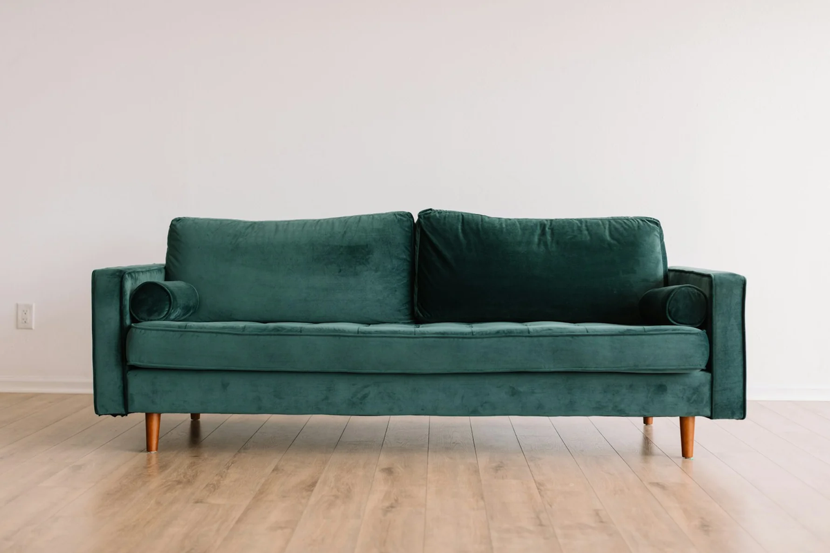Green upholstered sofa in a bright living room